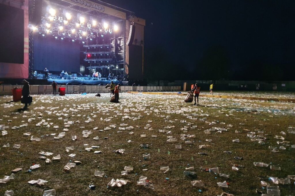 Litter pickers picking up festival waste after an event