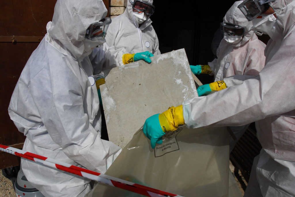 People in hazmat suits dealing with asbestos