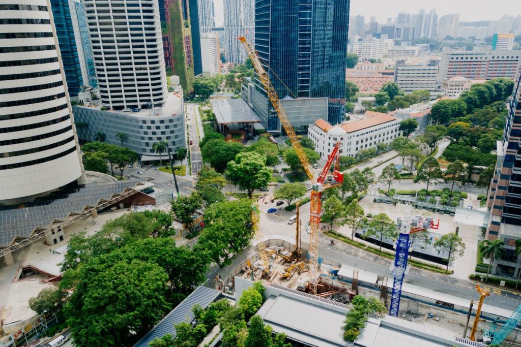 A birds eye view of a construction site with buildings and trees