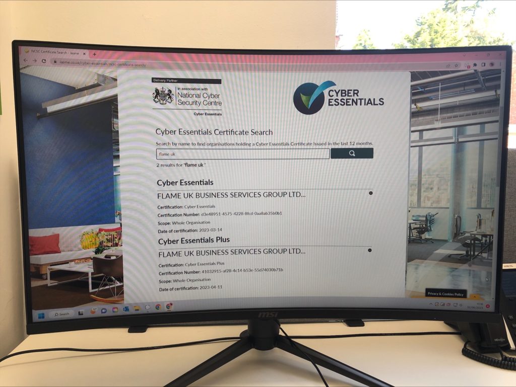 A photo of a computer displaying the cyber essentials plus certification for flame uk 