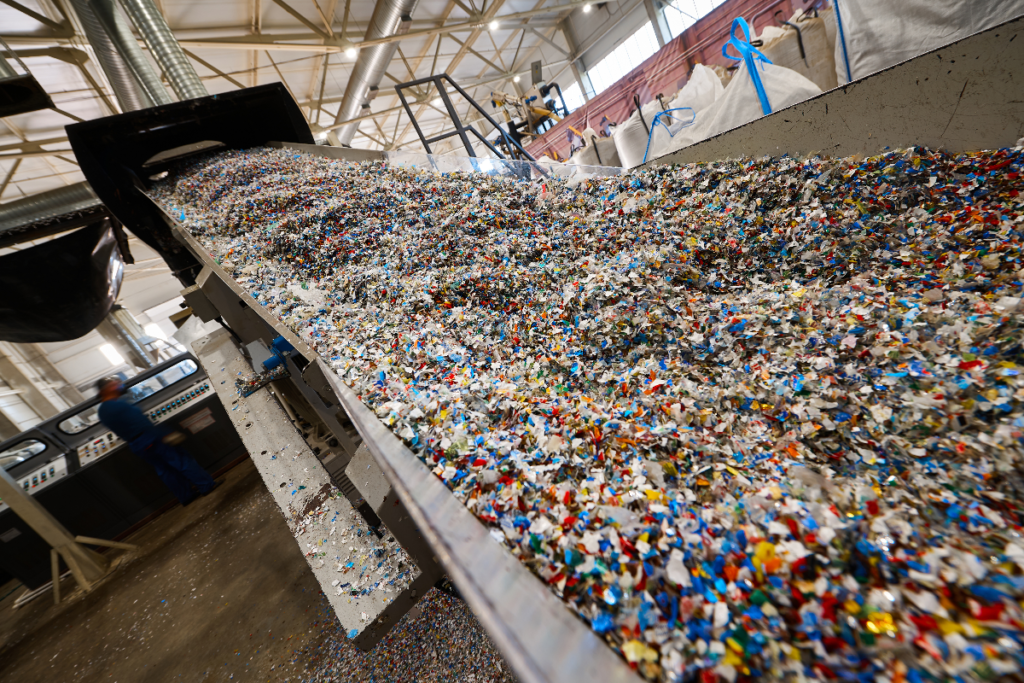 Pieces of plastic in a picking line at a recycling facility