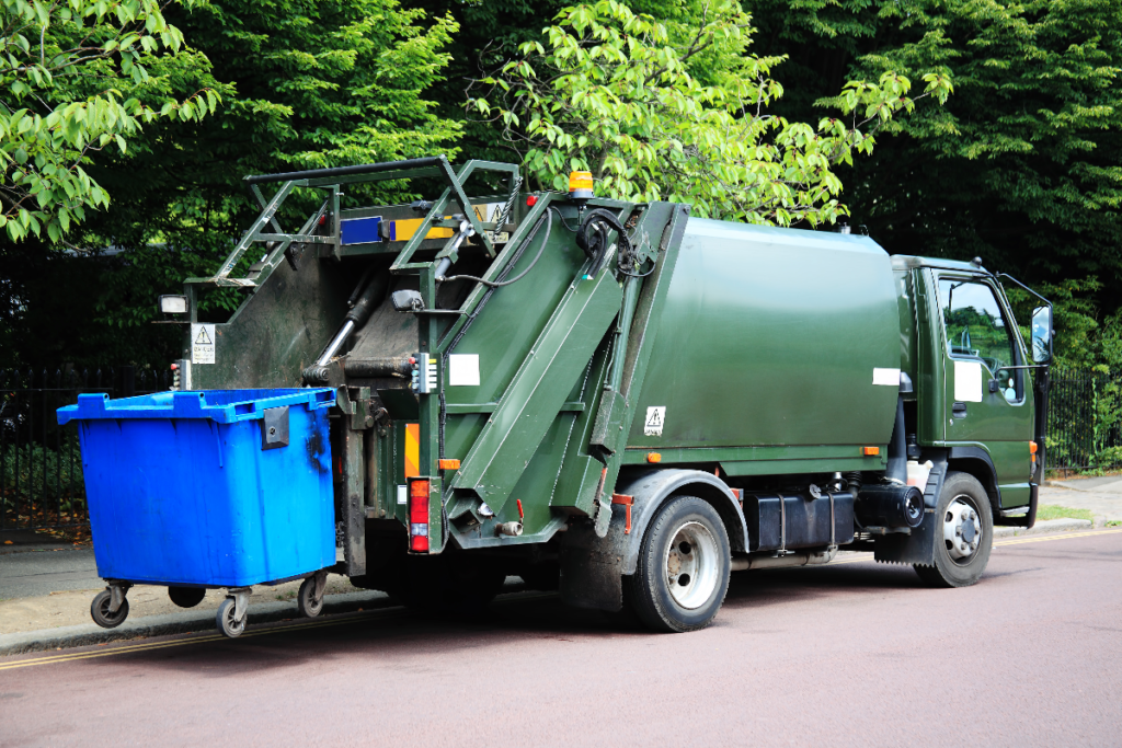 A waste truck collecting a bin for disposal